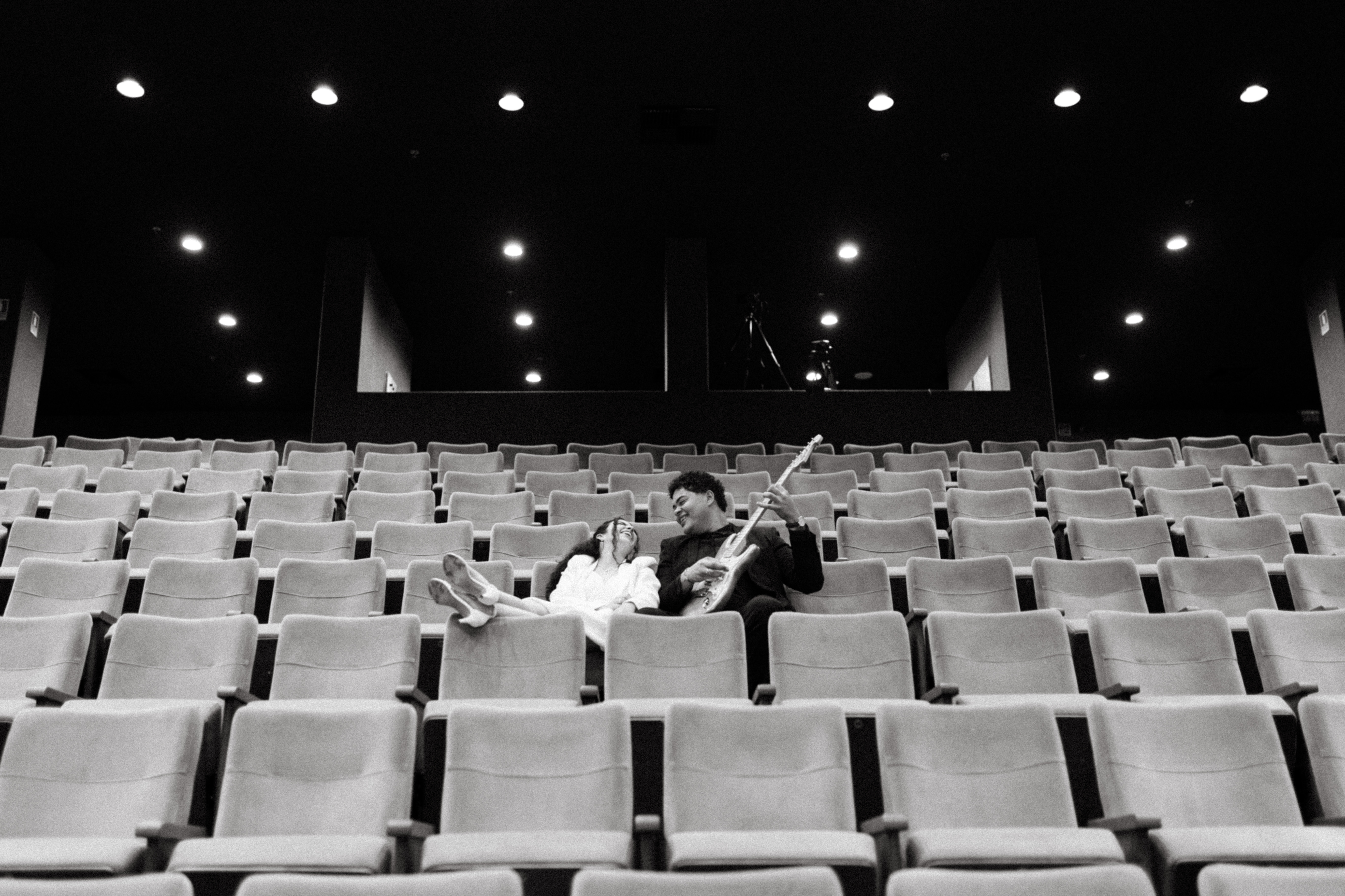 A man proposing to a woman on a cliff overlooking the sea.